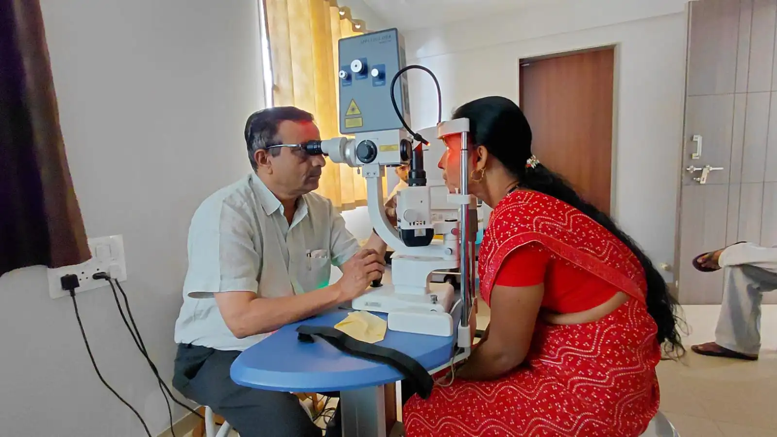 Ophthalmologist examining a patient during an eye emergency consultation